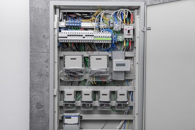 Photo of Fuse box with many electric meters and wires