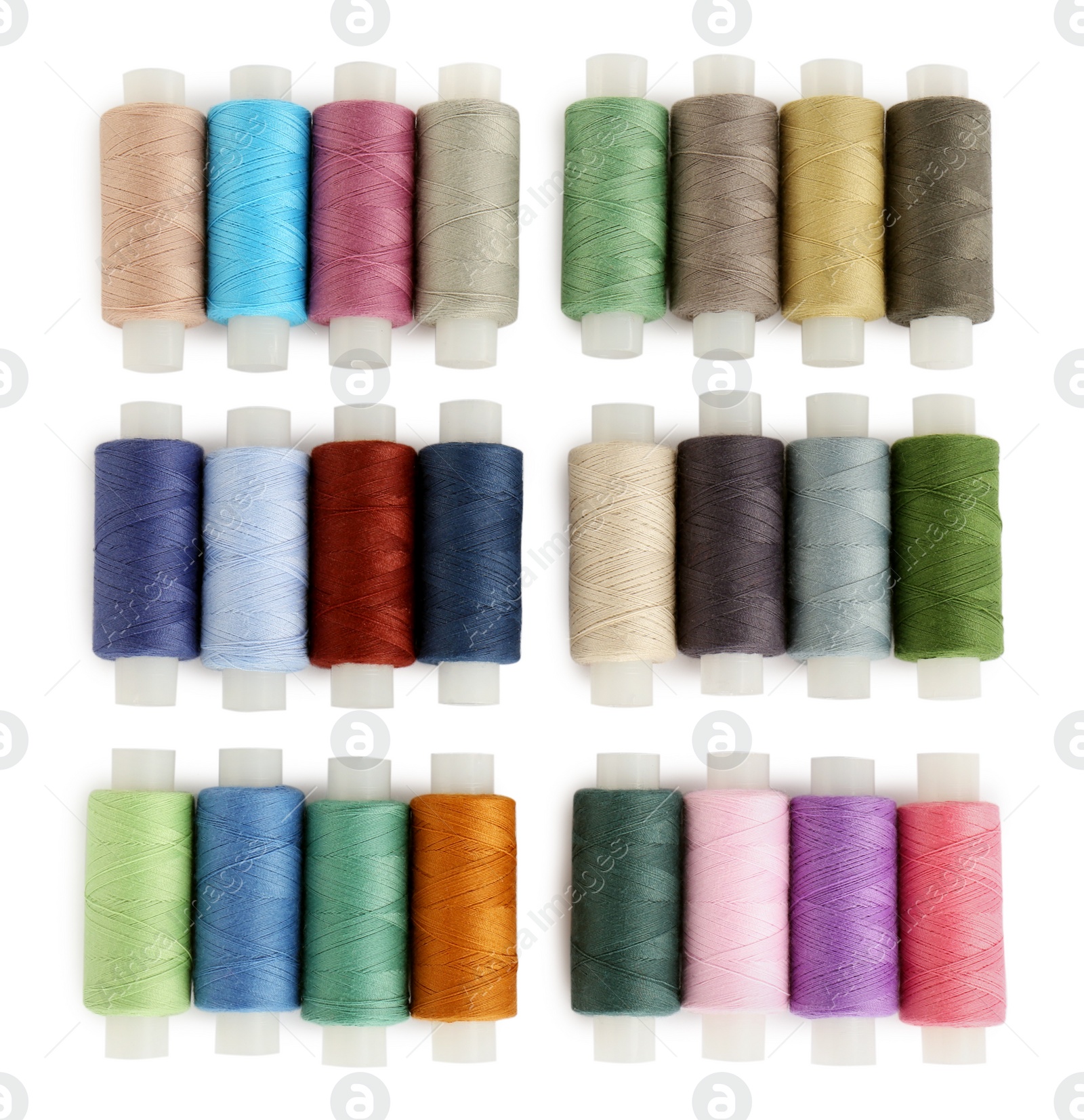 Photo of Set of colorful sewing threads on white background, top view