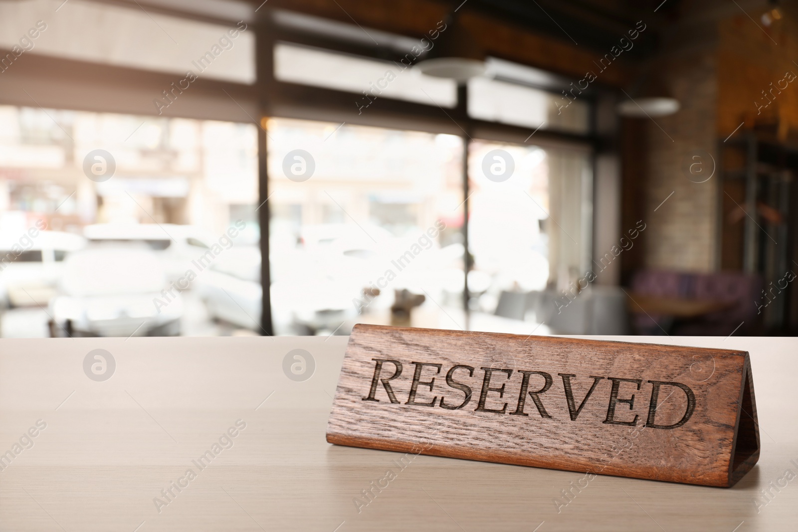 Image of Sign Reserved on white wooden table in restaurant
