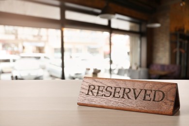 Image of Sign Reserved on white wooden table in restaurant
