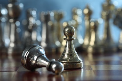 Photo of Pawn near fallen one on chessboard, selective focus
