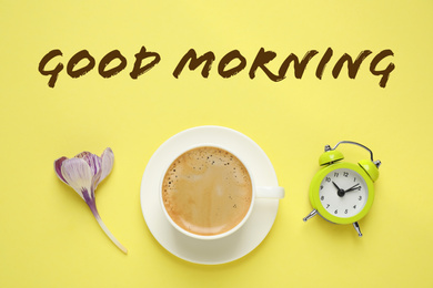 Image of Good Morning. Delicious morning coffee, alarm clock and flower on yellow background, flat lay