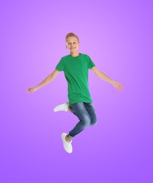 Happy boy jumping on color gradient background