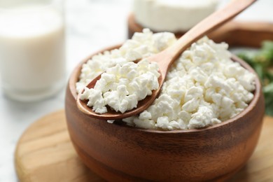 Photo of Delicious fresh cottage cheese in bowl on table, closeup
