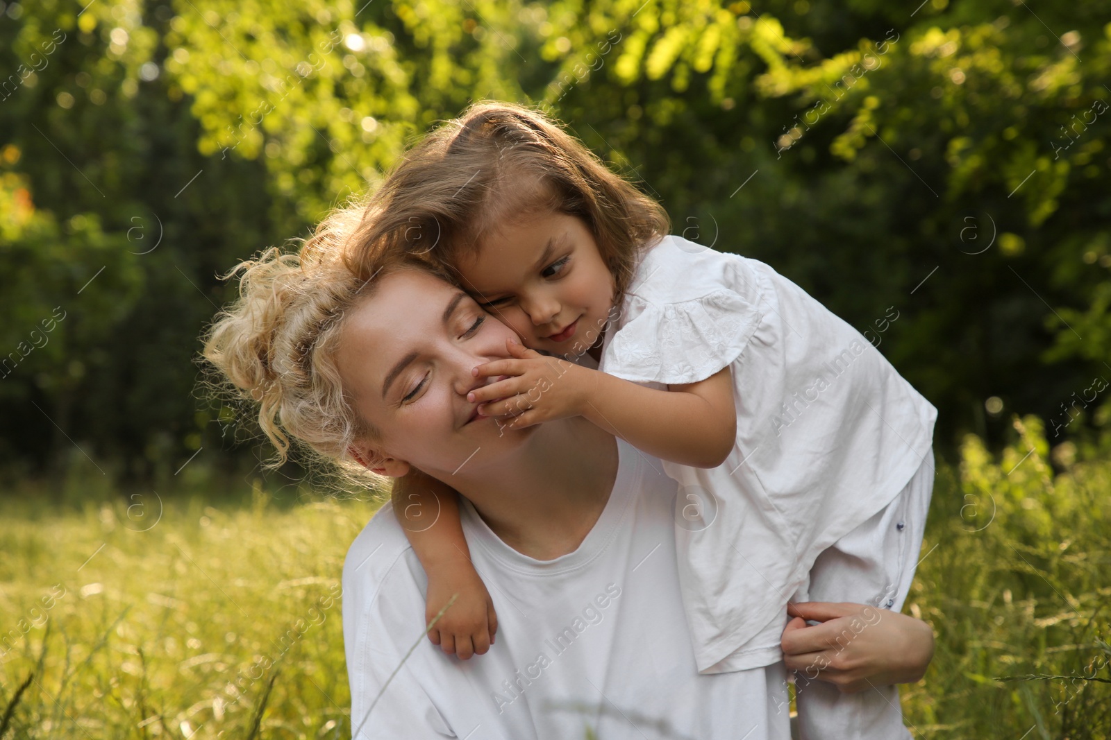 Photo of Beautiful mother with her cute daughter spending time together outdoors