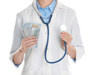 Photo of Doctor with bribe and stethoscope on white background, closeup. Corruption in medicine