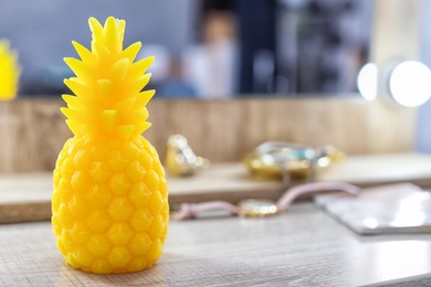 Pineapple shaped candle on table