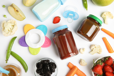 Flat lay composition with baby food, ingredients and accessories on white background