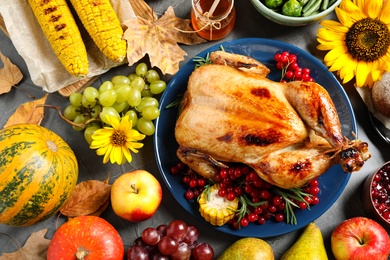 Photo of Flat lay composition with delicious turkey on grey background. Happy Thanksgiving day