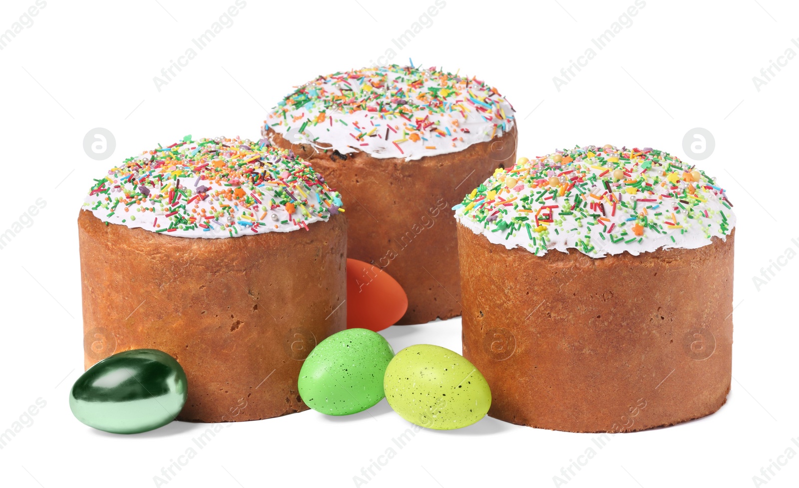 Photo of Traditional Easter cakes with sprinkles and painted eggs isolated on white