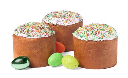 Photo of Traditional Easter cakes with sprinkles and painted eggs isolated on white
