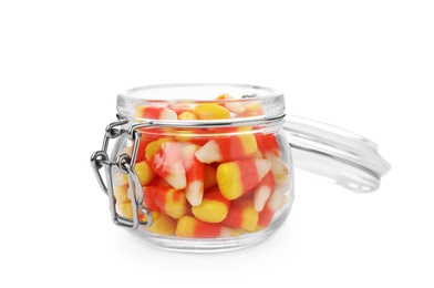 Photo of Colorful candy corns in jar on white background