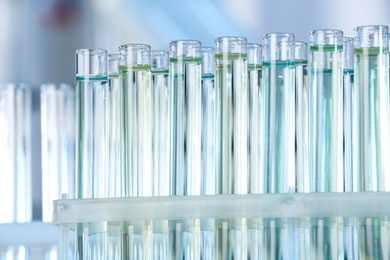 Photo of Test tubes with liquid samples for analysis in laboratory, closeup