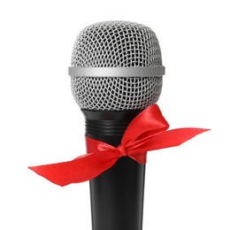 Photo of Microphone with red bow isolated on white, closeup. Christmas music