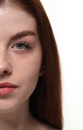 Photo of Beautiful woman with freckles on white background, closeup