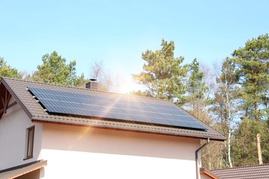 Photo of House with installed solar panels on roof. Alternative energy