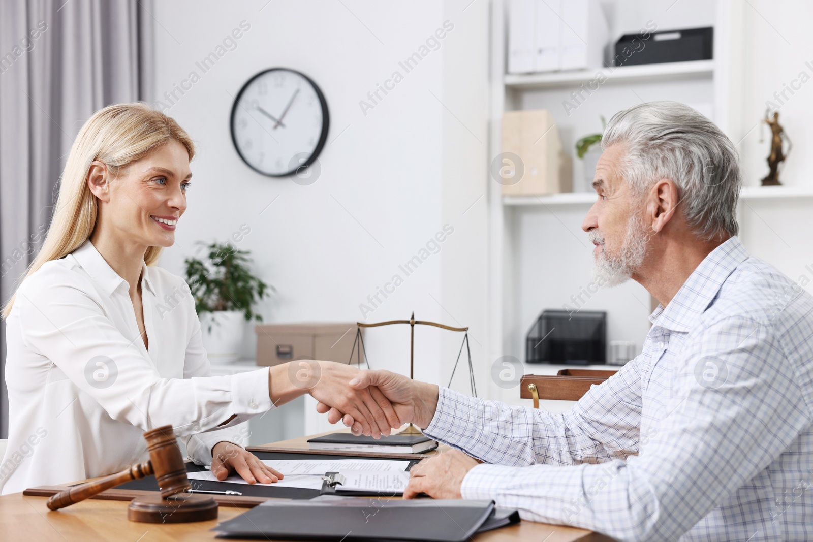 Photo of Lawyer shaking hands with client in office