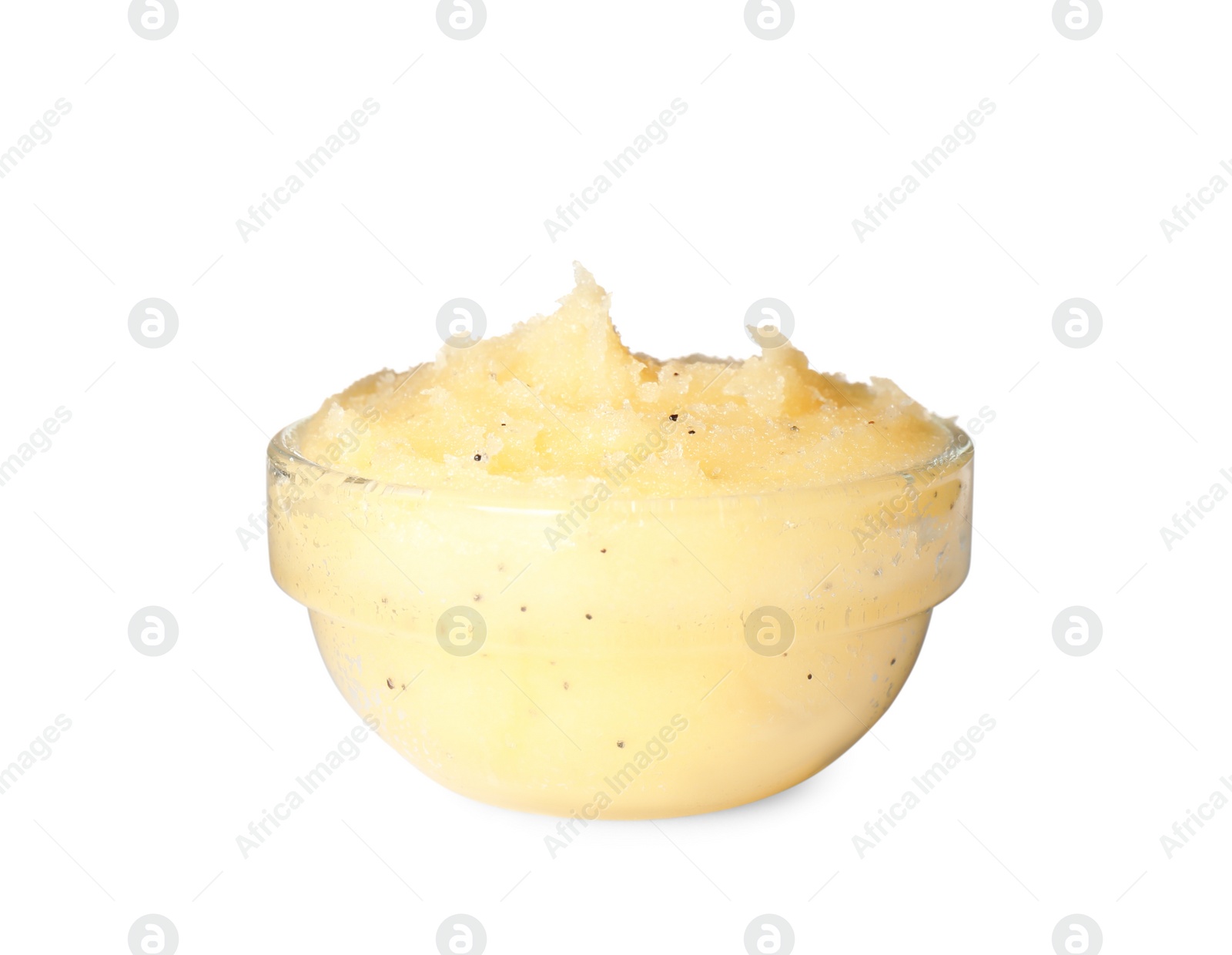 Photo of Glass bowl of yellow body scrub isolated on white