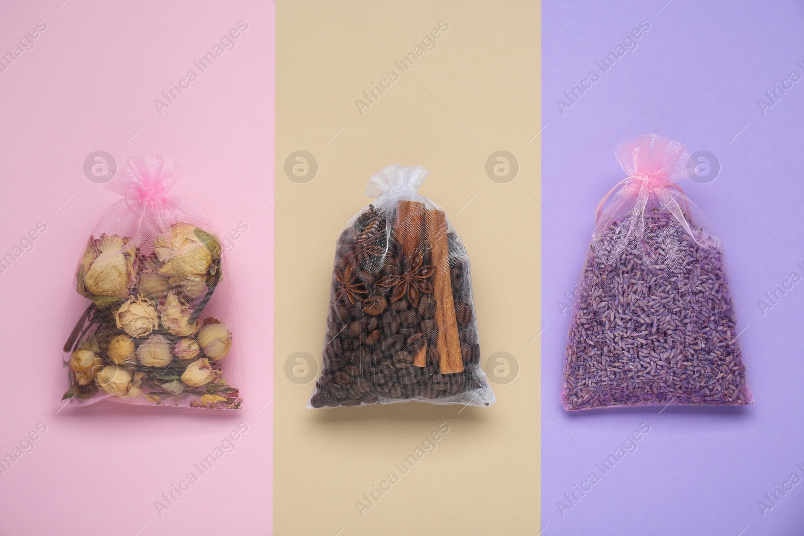 Photo of Scented sachets with dried flowers, coffee beans and spices on color background, flat lay