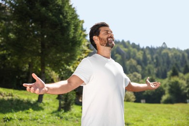 Photo of Feeling freedom. Happy man with wide open arms on sunny day