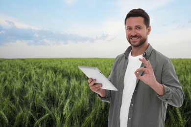 Image of Farmer with tablet computer in field. Harvesting season