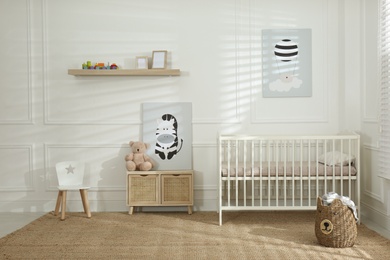 Light baby room interior with comfortable crib