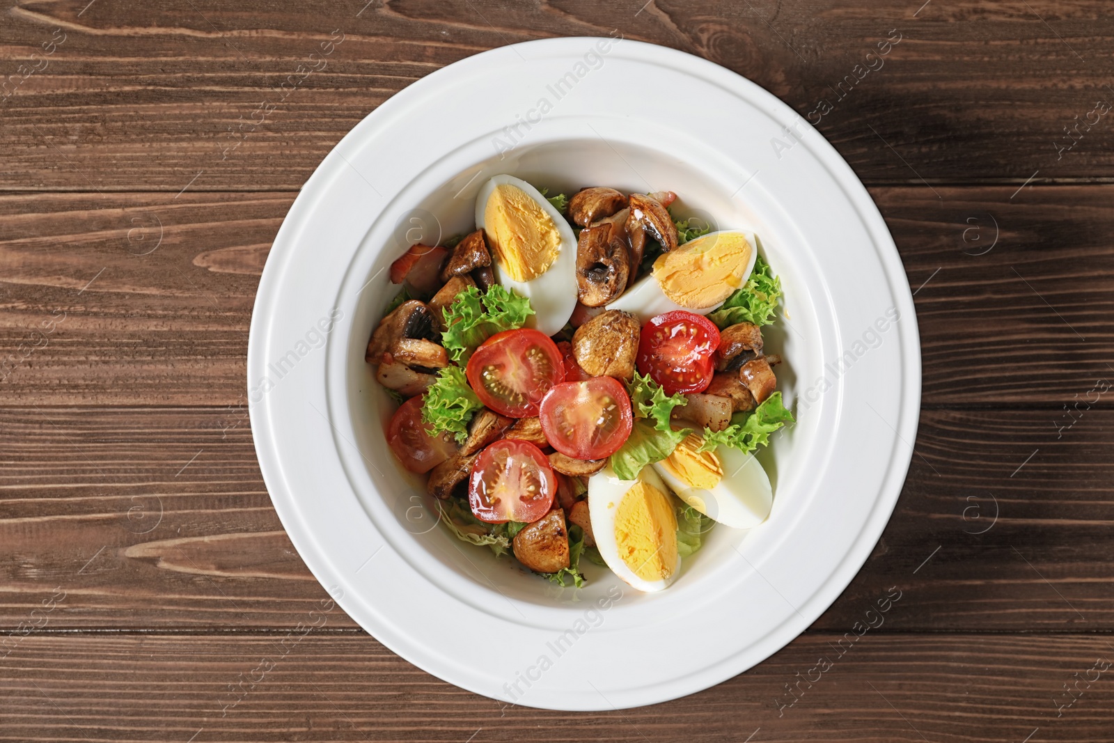 Photo of Plate with delicious fresh salad on table, top view