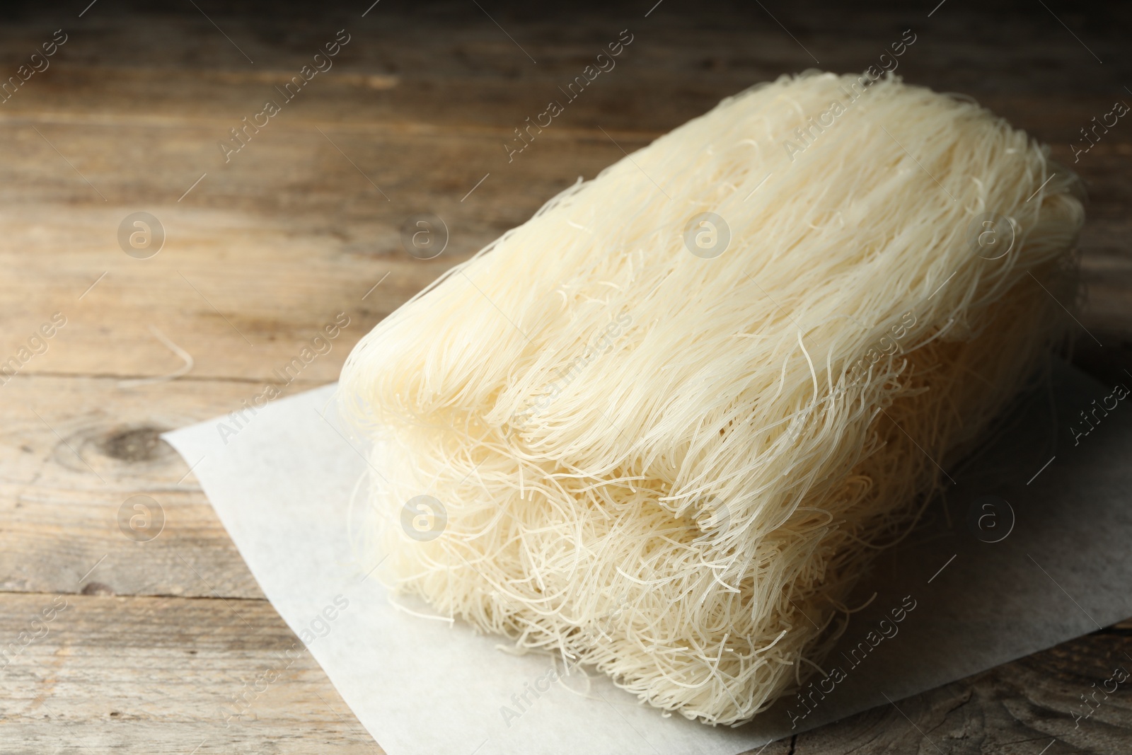 Photo of Block of rice noodles on wooden table, closeup