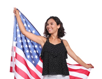 Happy young woman with American flag on white background