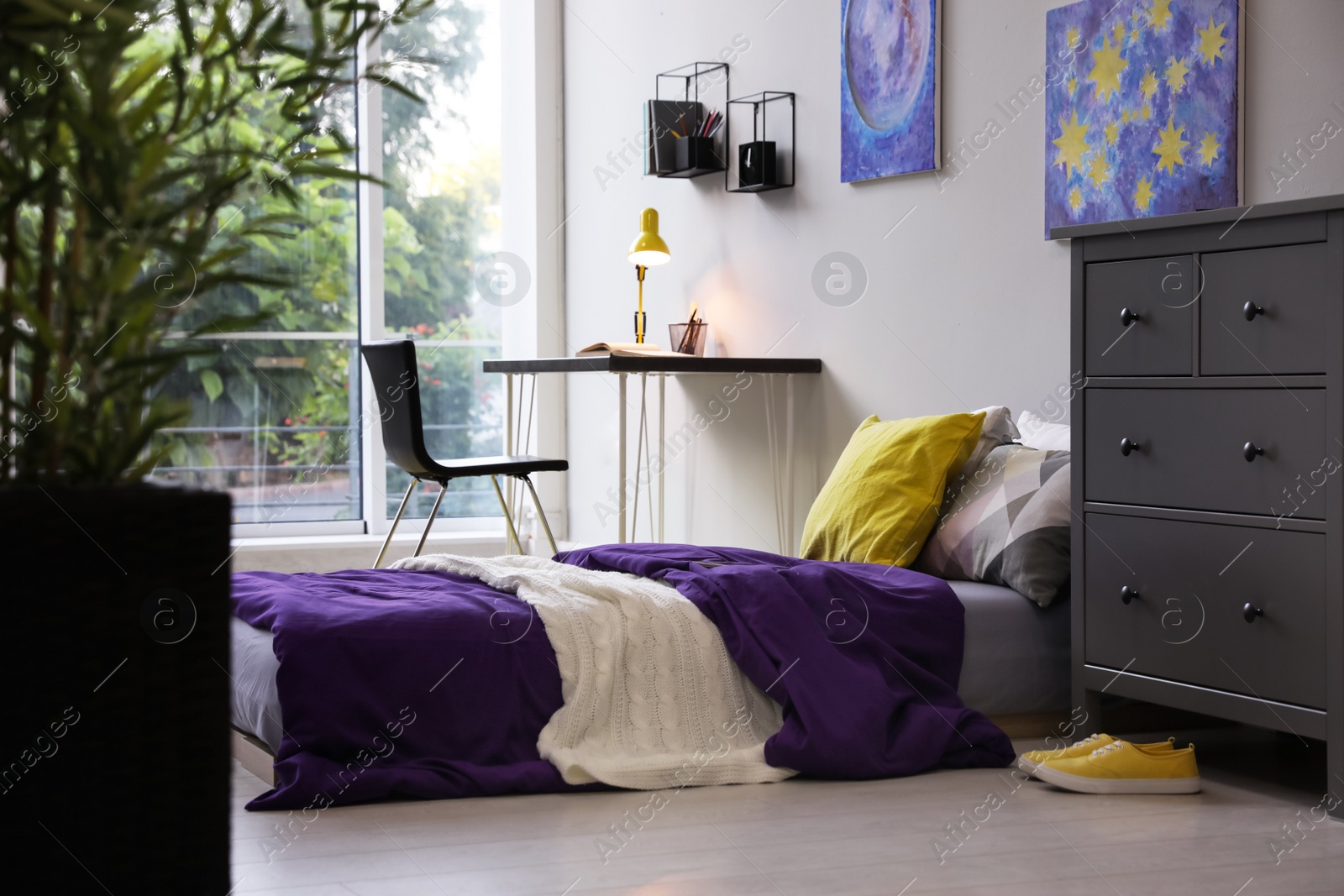 Photo of Modern teenager's room interior with comfortable bed, workplace and stylish design elements
