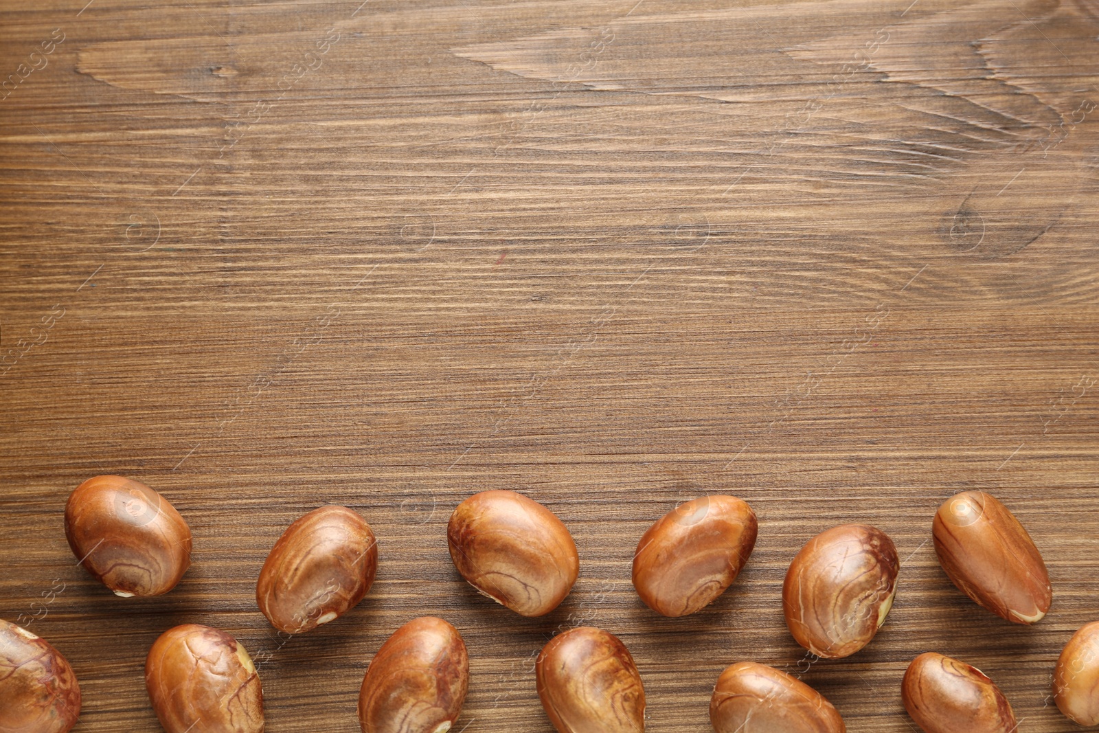 Photo of Jackfruit seeds on wooden table, flat lay. Space for text