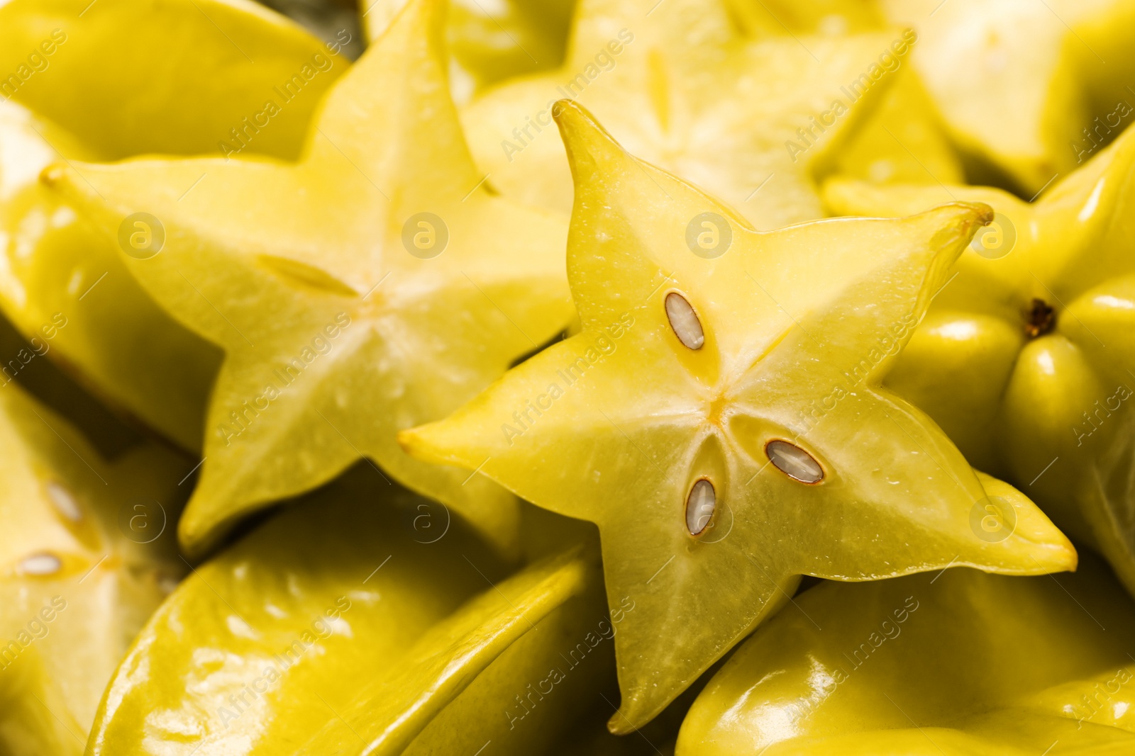 Photo of Cut and whole carambolas as background, closeup