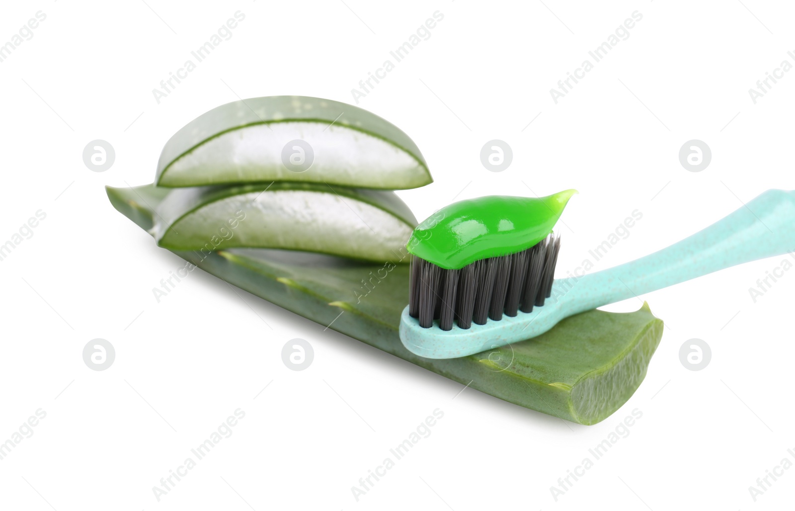 Photo of Brush with toothpaste and green aloe leaves on white background