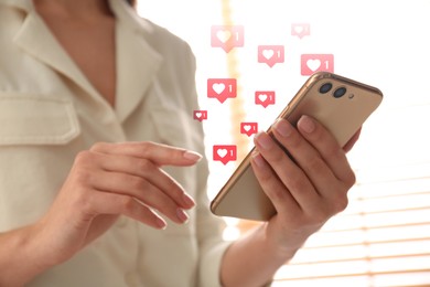 Young woman using smartphone indoors, closeup. Social media