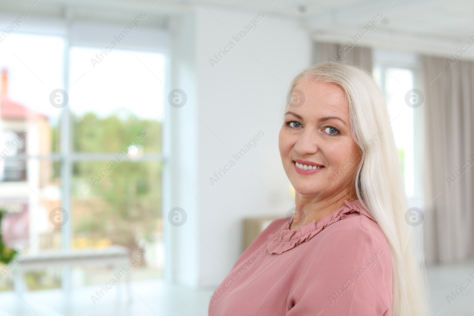 Photo of Portrait of beautiful older woman against blurred background with space for text