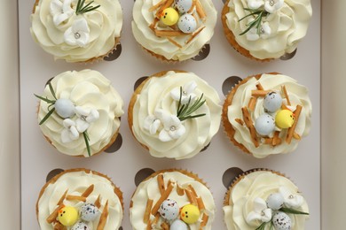 Tasty Easter cupcakes in box, top view