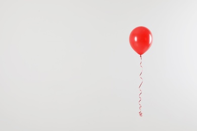 Photo of Bright balloon on light background, space for text. Celebration time