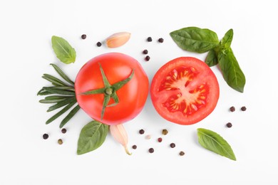 Flat lay composition with whole and cut tomatoes on white background