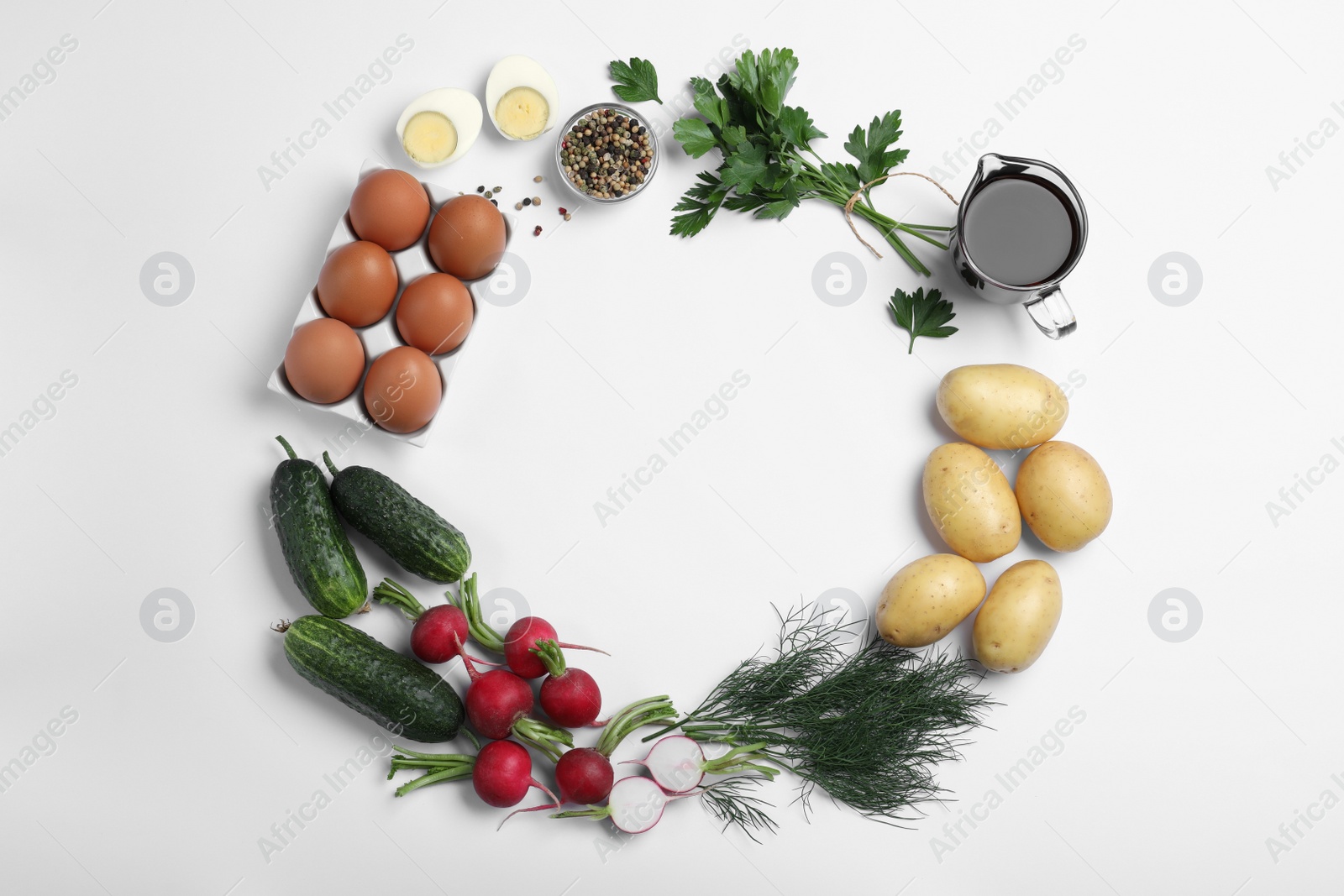 Photo of Frame of kvass and other okroshka ingredients on white background, top view with space for text. Traditional Russian summer soup