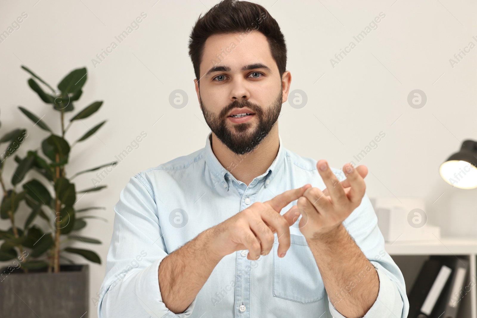 Photo of Young man having video chat indoors, view from web camera