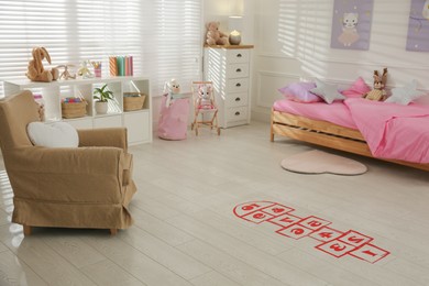 Photo of Red hopscotch floor sticker in bedroom at home