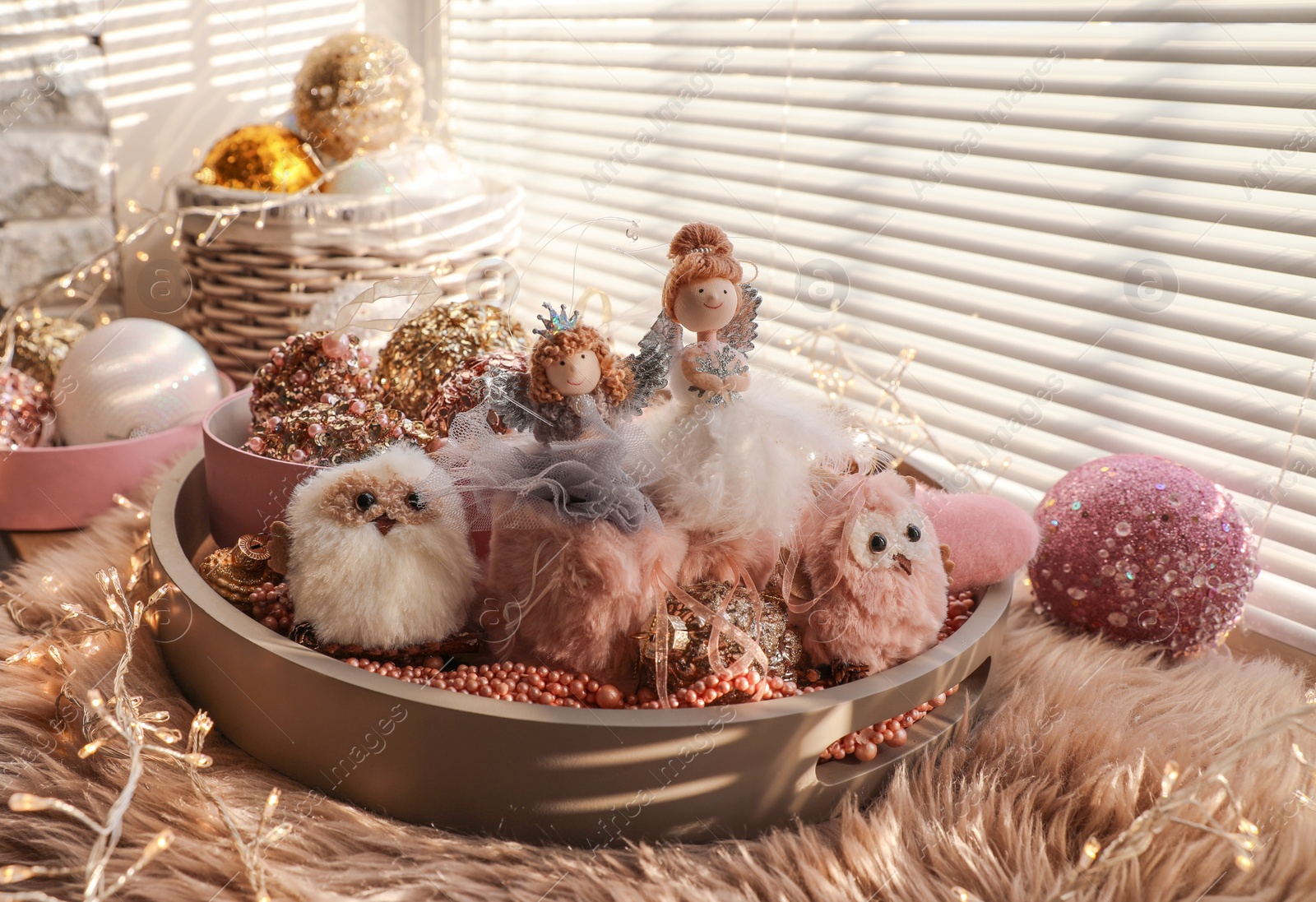 Photo of Beautiful Christmas tree baubles, toys and fairy lights on window sill indoors