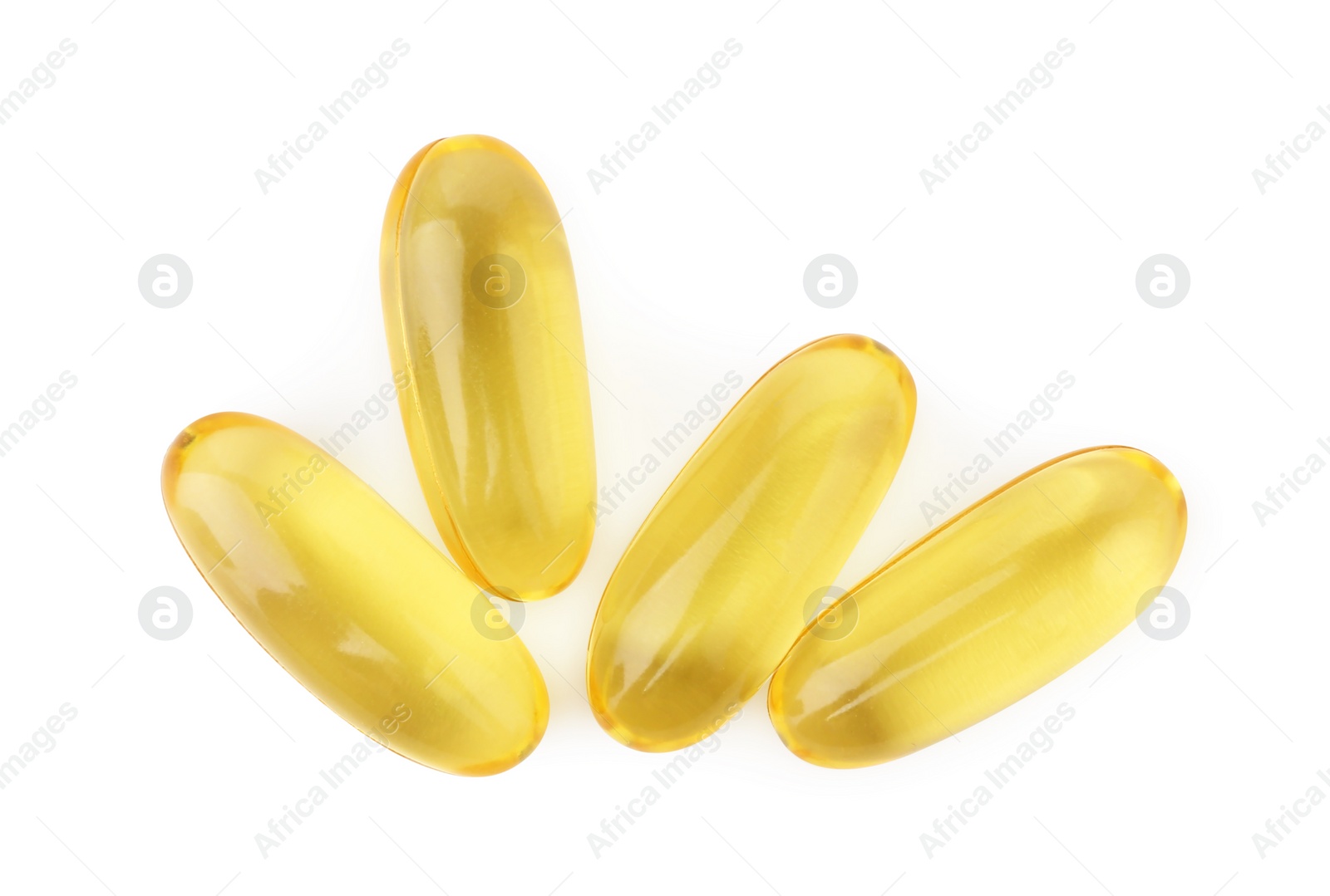 Photo of Many yellow vitamin capsules isolated on white, top view