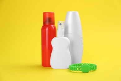 Photo of Set of different insect repellents on yellow background