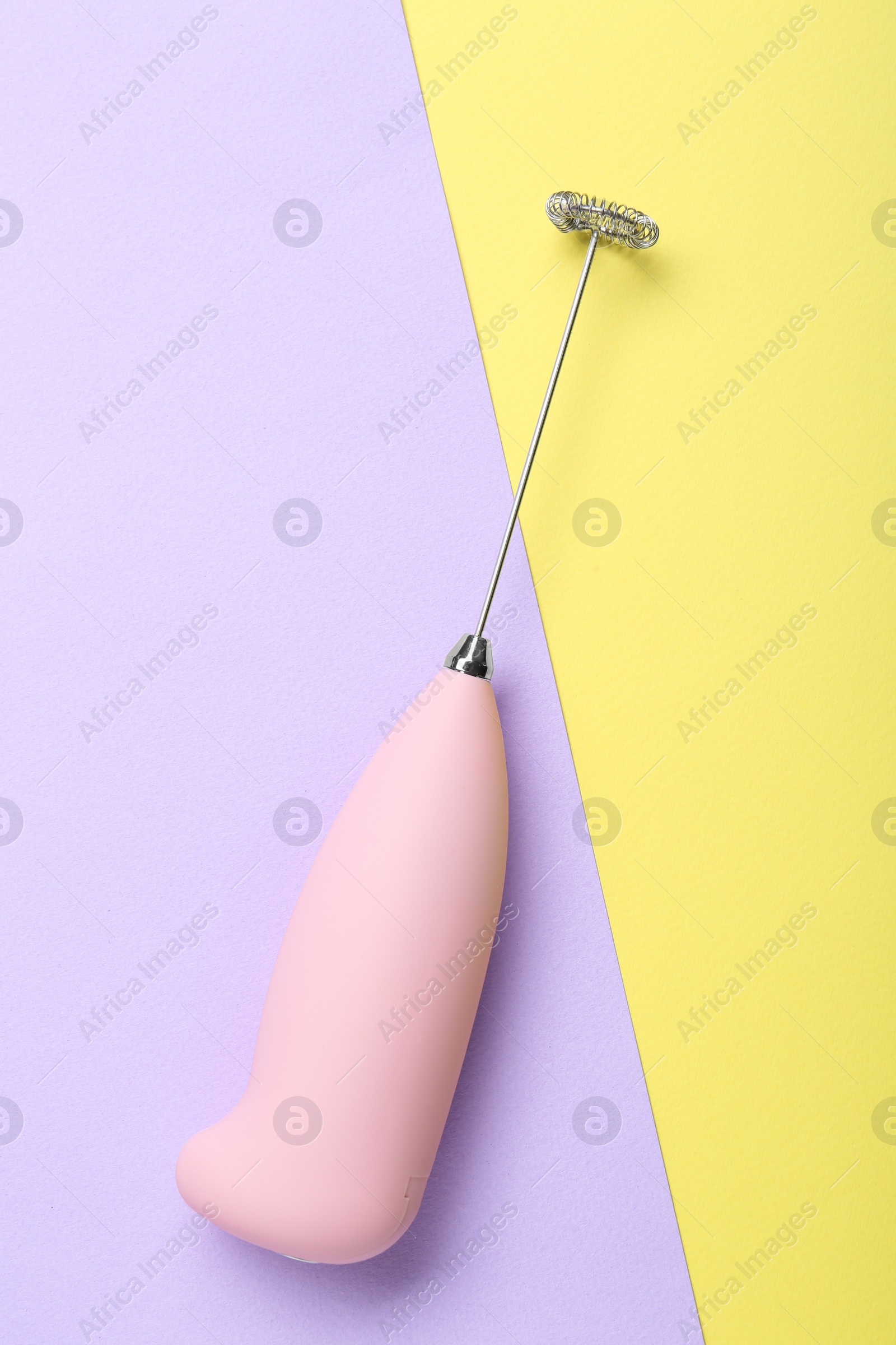 Photo of Pink milk frother wand on color background, top view