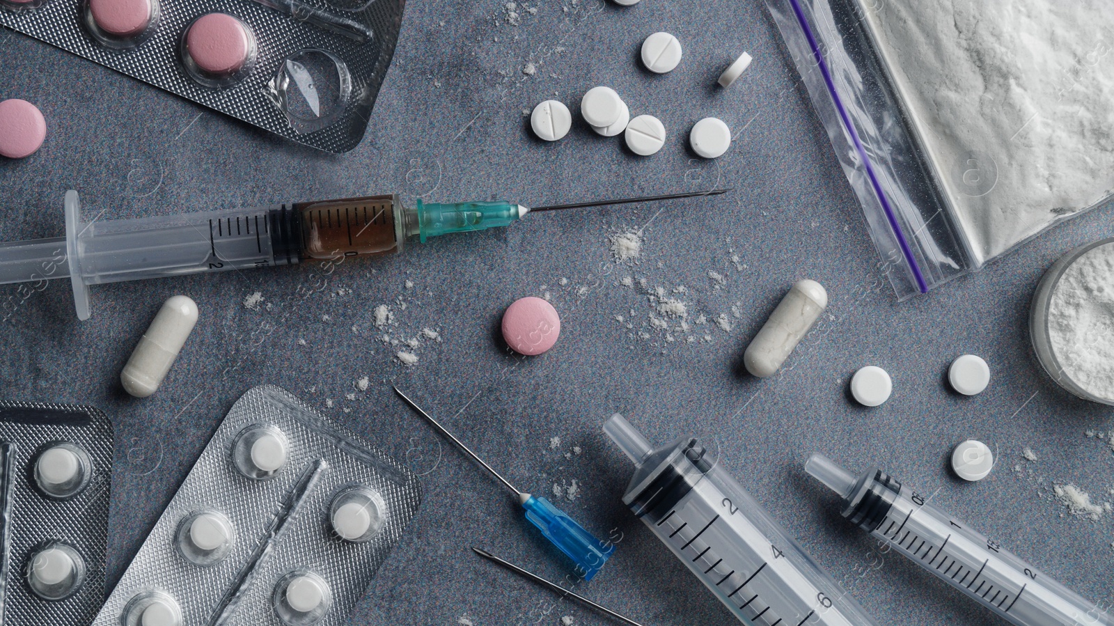 Photo of Many different hard drugs on light grey table, flat lay