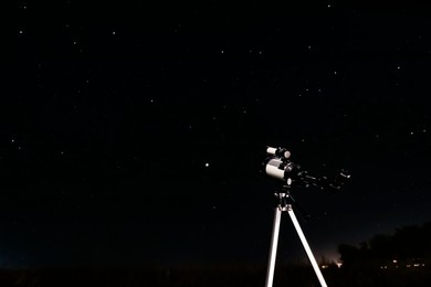 New astronomy telescope outdoors, space for text. Picturesque view of shiny stars at night