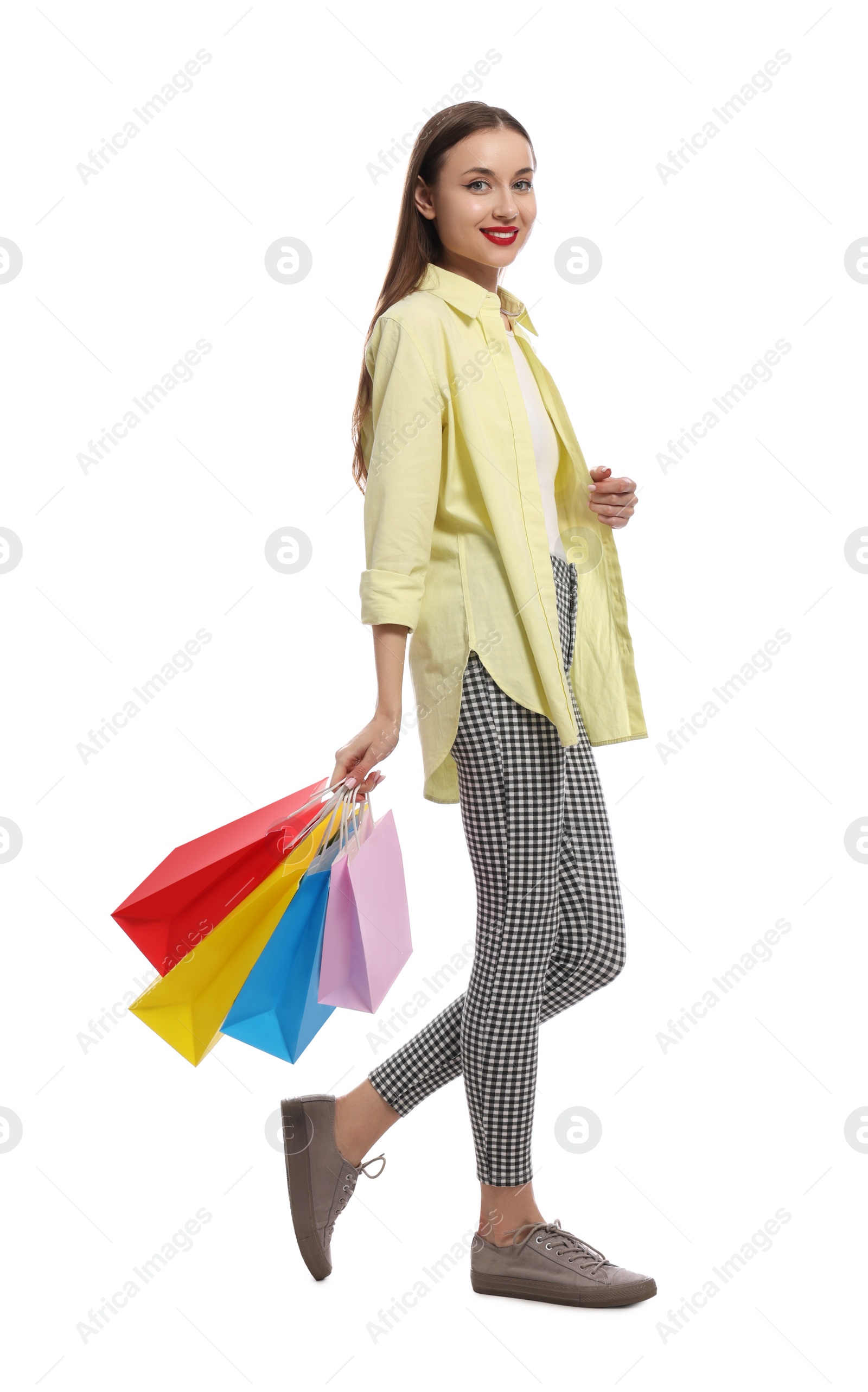 Photo of Stylish young woman with shopping bags on white background