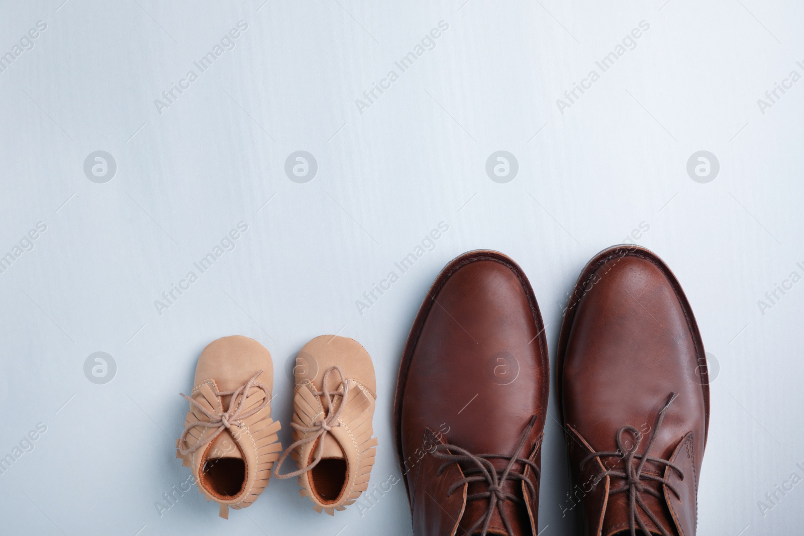 Photo of Flat lay composition with shoes and space for text on gray background. Happy Father's Day