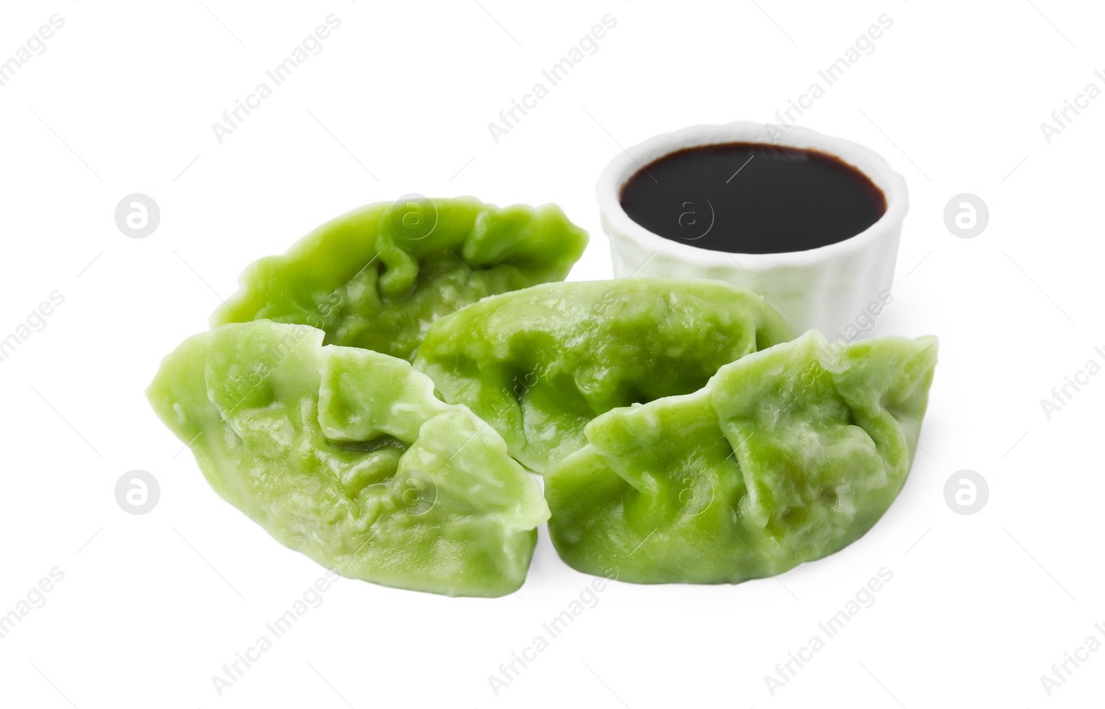 Photo of Delicious green dumplings (gyozas) and soy sauce isolated on white